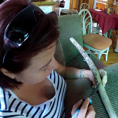 A hiker making her own walking stick